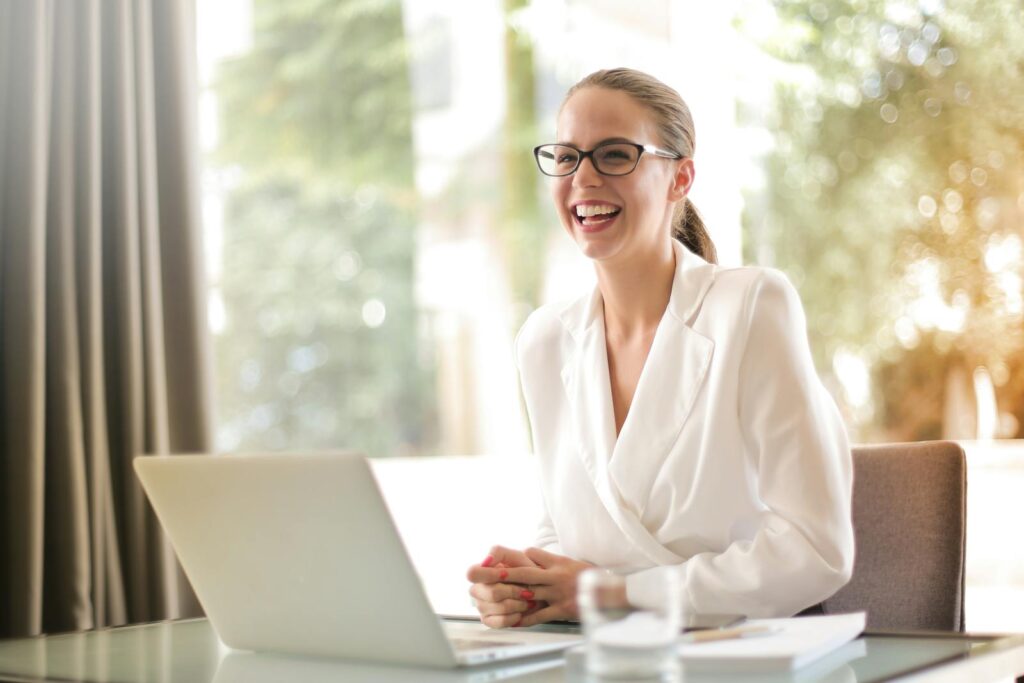 Get Paid to Transcribe Audio: Start Earning with Transcription Jobs 1 Laughing businesswoman working in office with laptop