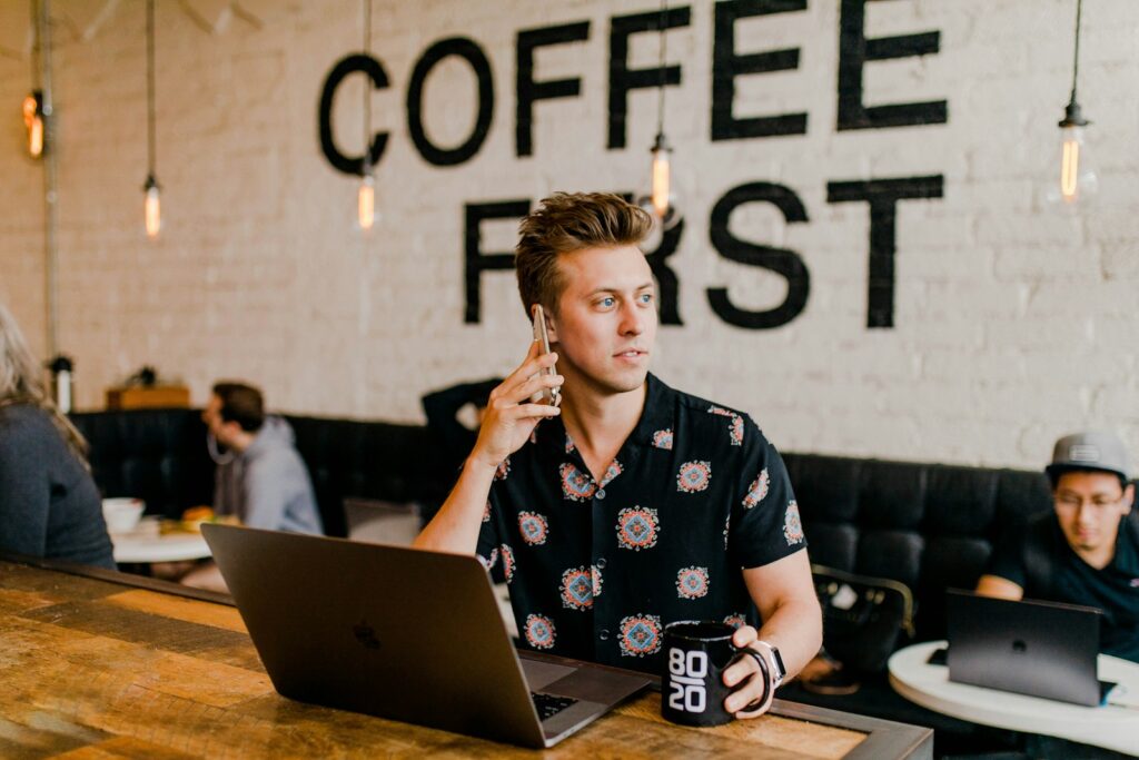 How to Test Websites for Cash in Your Free Time 1 man holding phone white using MacBook